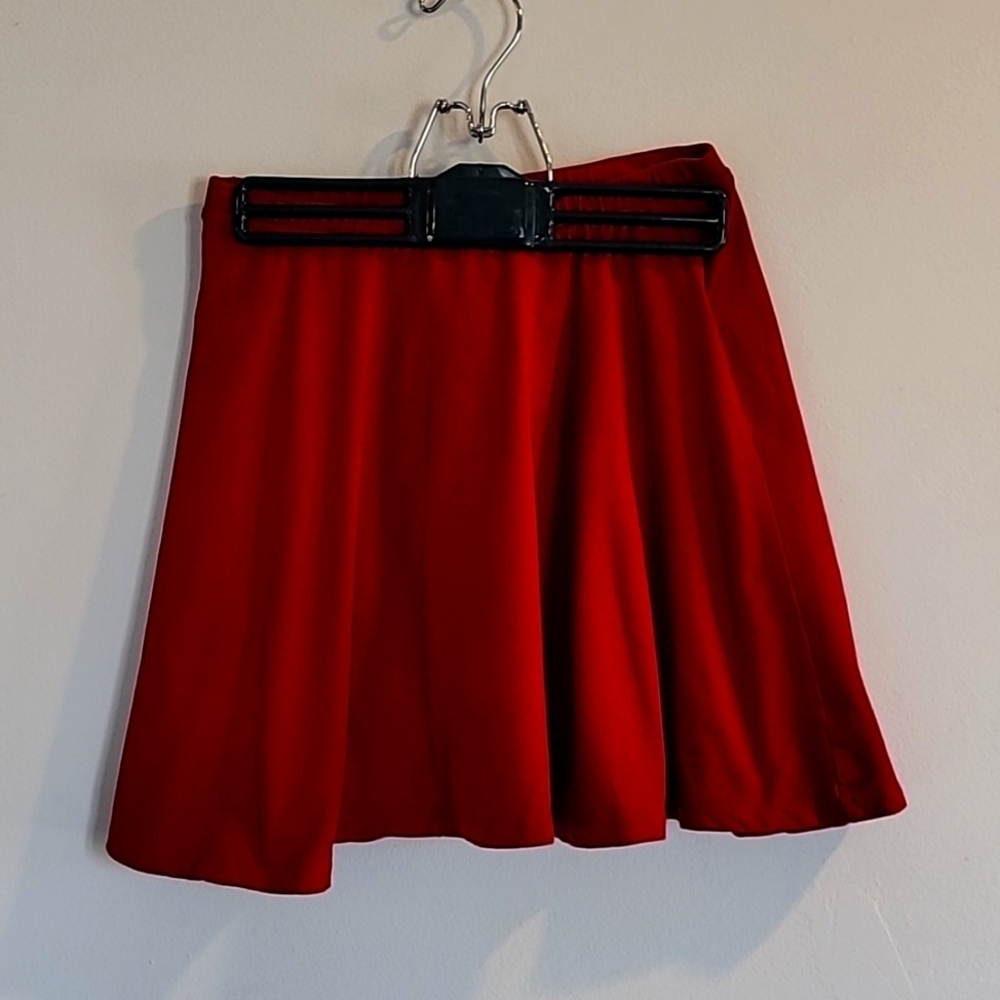 Red, pleated mini-skirt in juniors size medium.